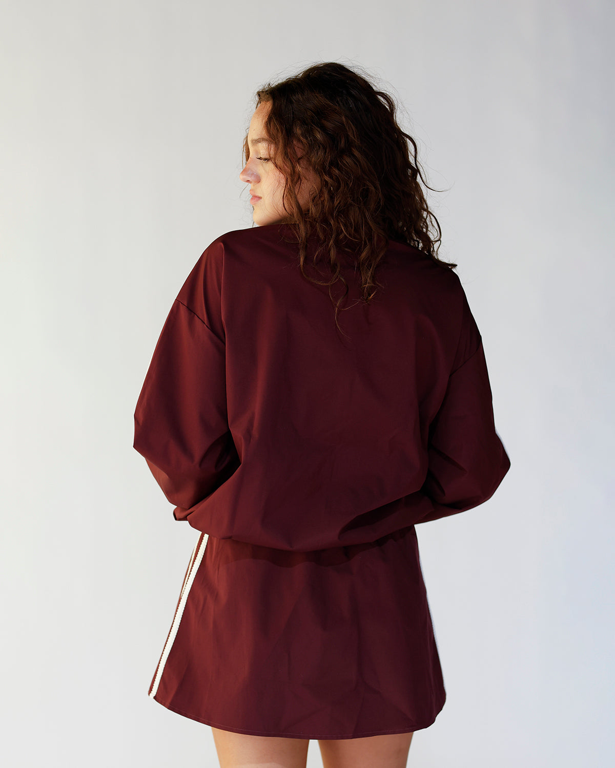 ON THE MOVE MAROON TRACK MINI SKIRT