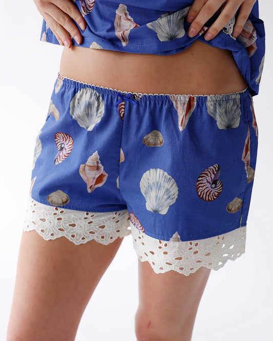 blue shorts with seashell print and crochet lace trim detail