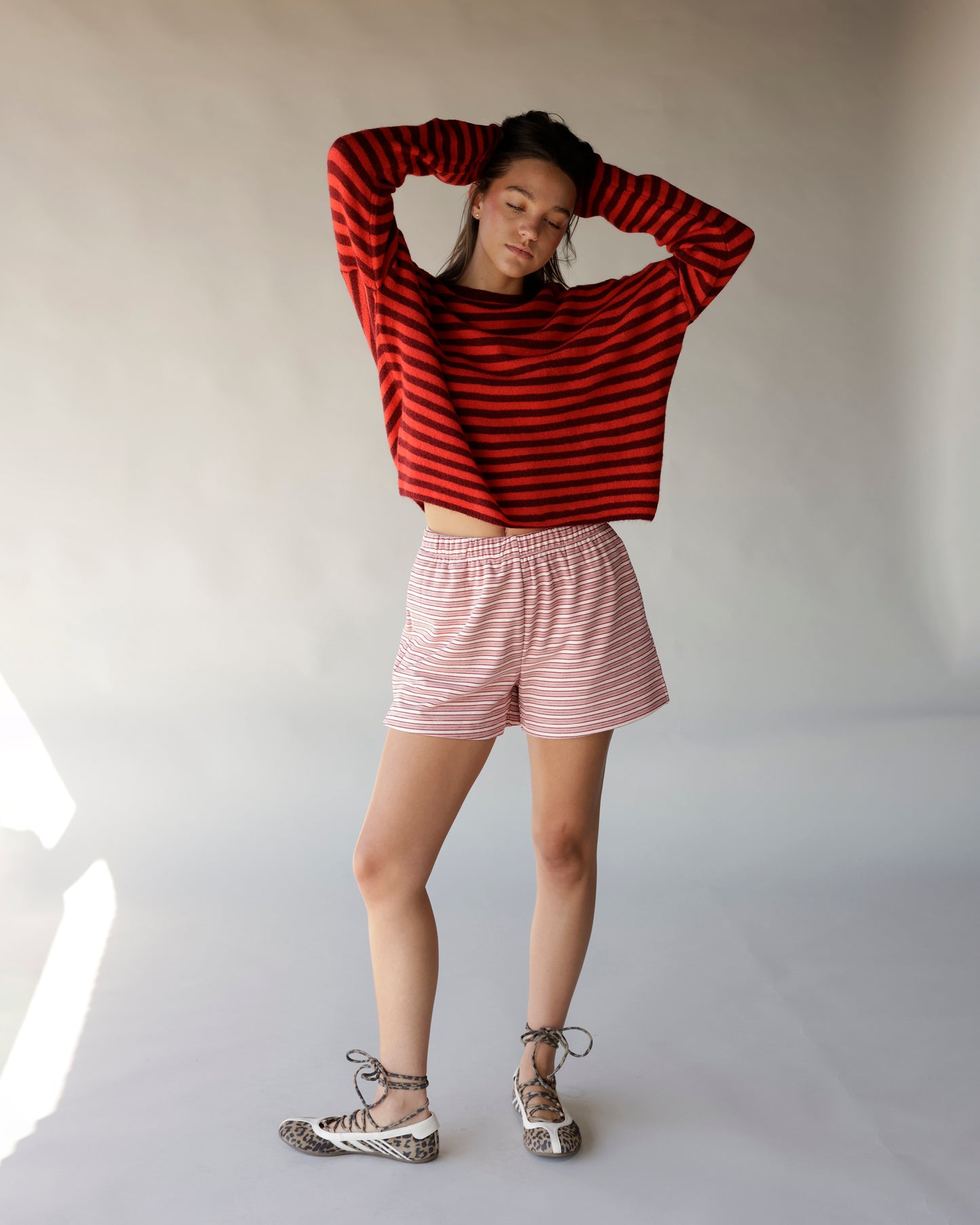 Cropped red and burgundy striped long-sleeve mock neck sweater with oversized fit