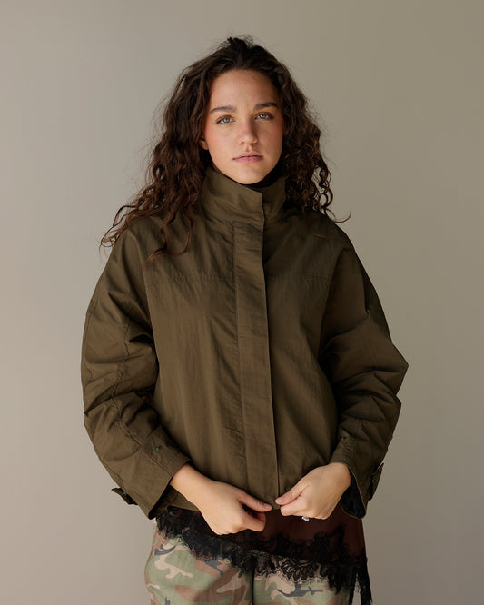 mimosa olive green women's utility jacket with high stand collar, front zipper, relaxed sleeves and adjustable gathered hem.
