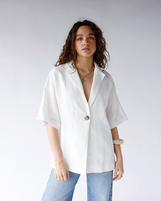 white linen short sleeve v-neckline tee with textured gold metal button