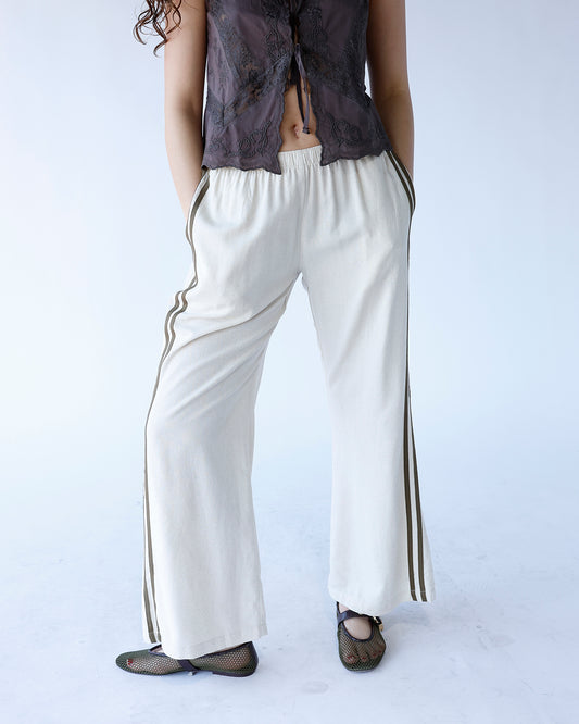 cream wide leg track pants with olive green track stripes