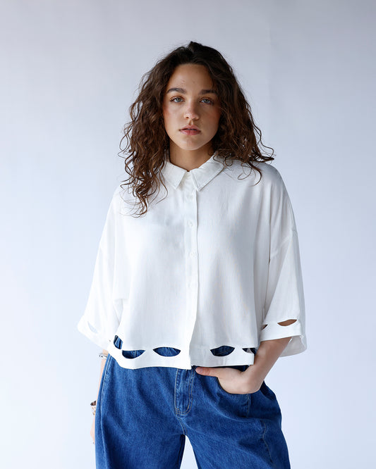 white button front collared blouse with cut-out details and quarter sleeves