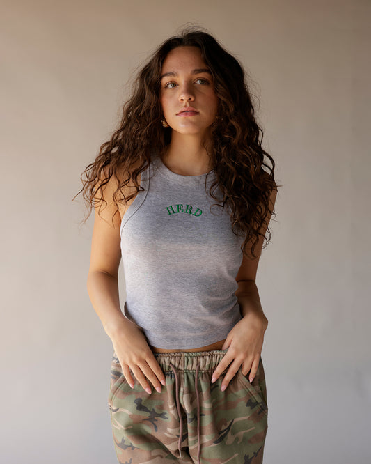 Gray racerback tank top with green HERD embroidery, paired with camo joggers