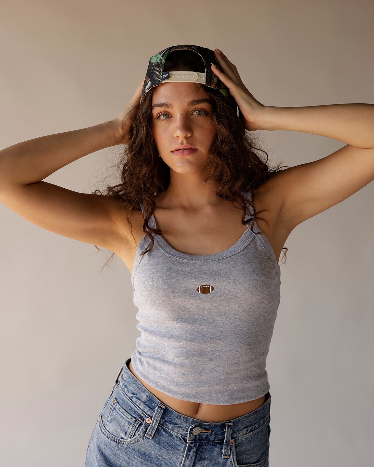 Kentucky Wildcats camo snapback trucker hat worn backwards by female model