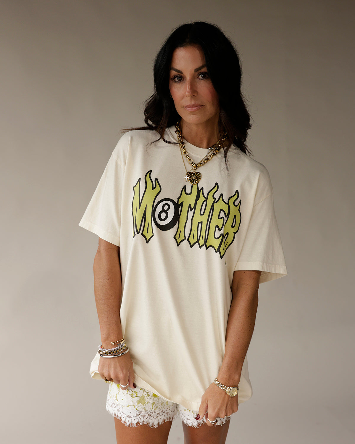 Cream oversized graphic tee with flaming MOTHER 8-ball logo in yellow and black