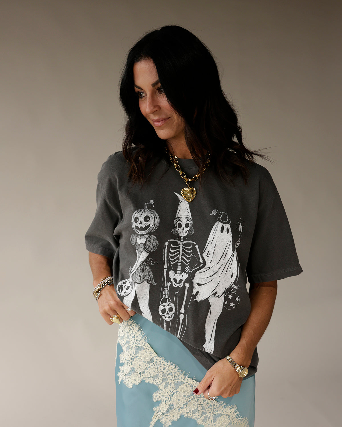 Dark gray oversized graphic tee with Halloween skeleton, ghost, and pumpkin print