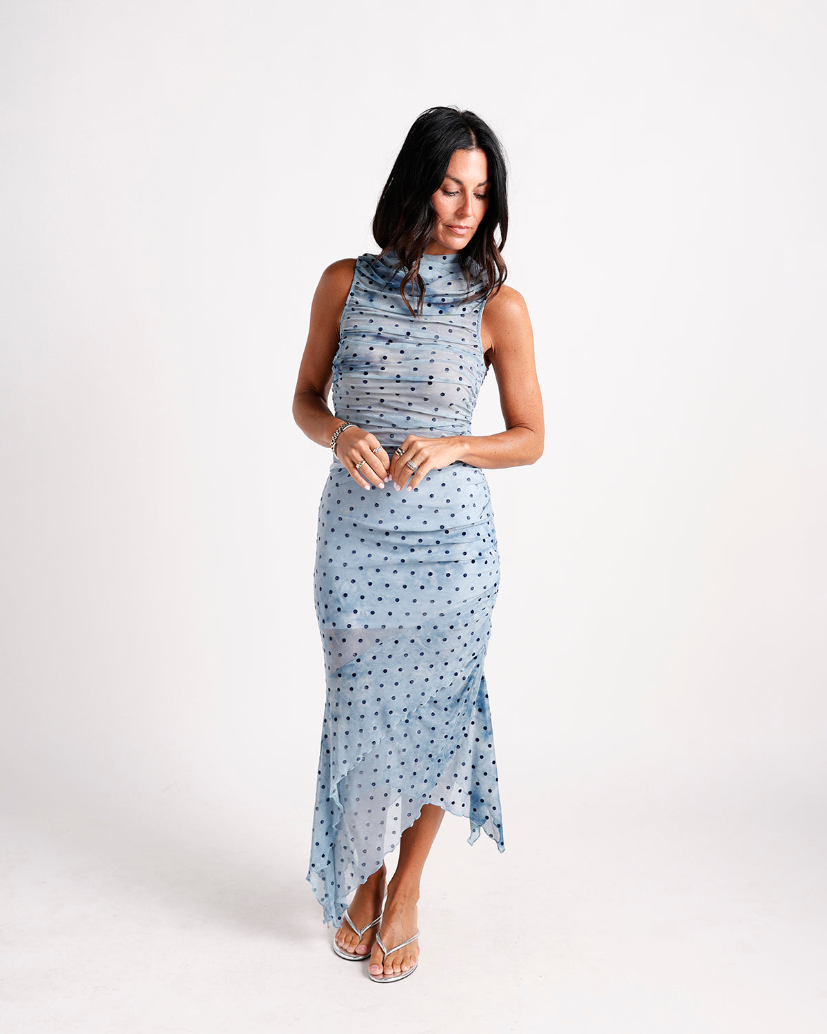 Blue polka dot ruched mesh midi dress with mock neck and asymmetric hem