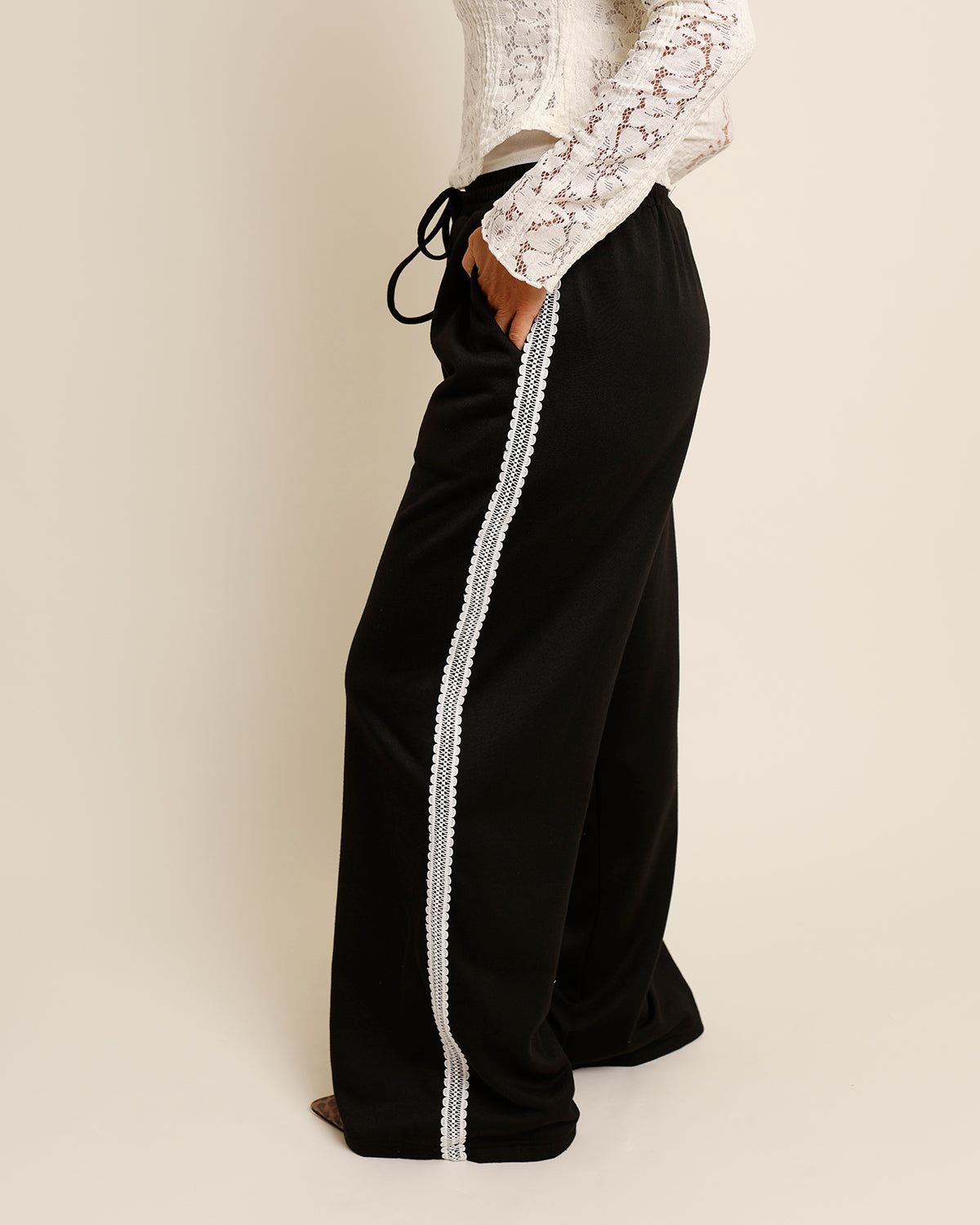 Black pants with white lace trim