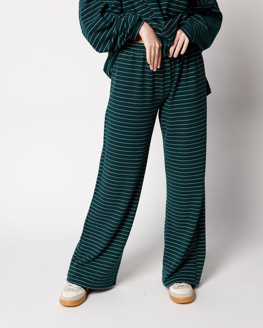 Hunter green wide-leg lounge pants with thin white horizontal stripes and elastic waist
