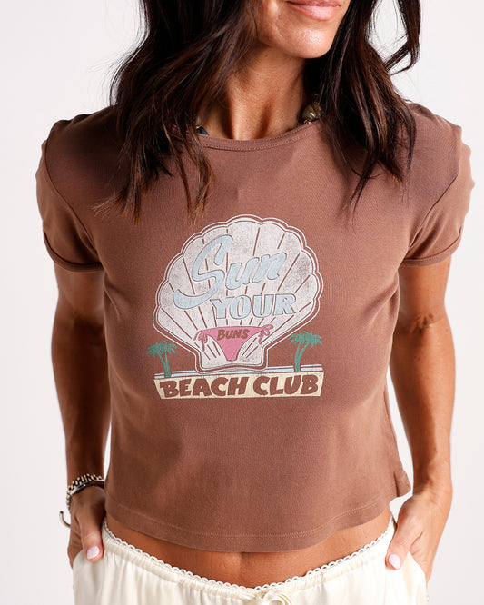 Brown ribbed crop tee with vintage shell graphic reading Sun Your Buns Beach Club