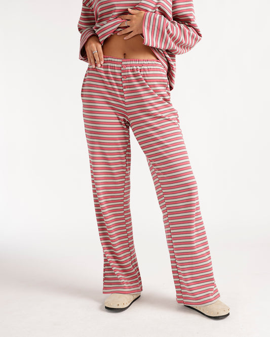 Relax in style with these red multi-stripe wide-leg pants featuring a comfortable elastic waistband, decorative button detail, and flowy silhouette. Pair them with the matching top or your favorite basics for an effortlessly cozy, everyday look perfect for lounging, errands, and weekend wear.