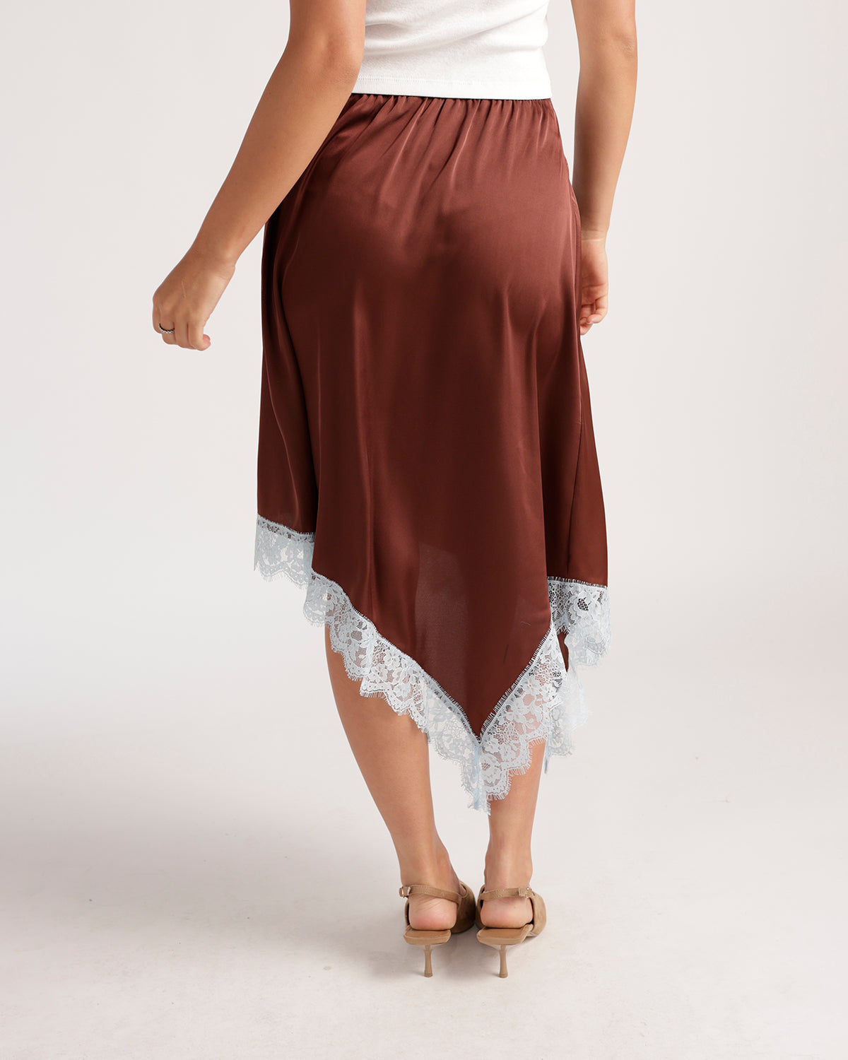 Brown satin asymmetric midi skirt with white lace trim hem and elastic waist