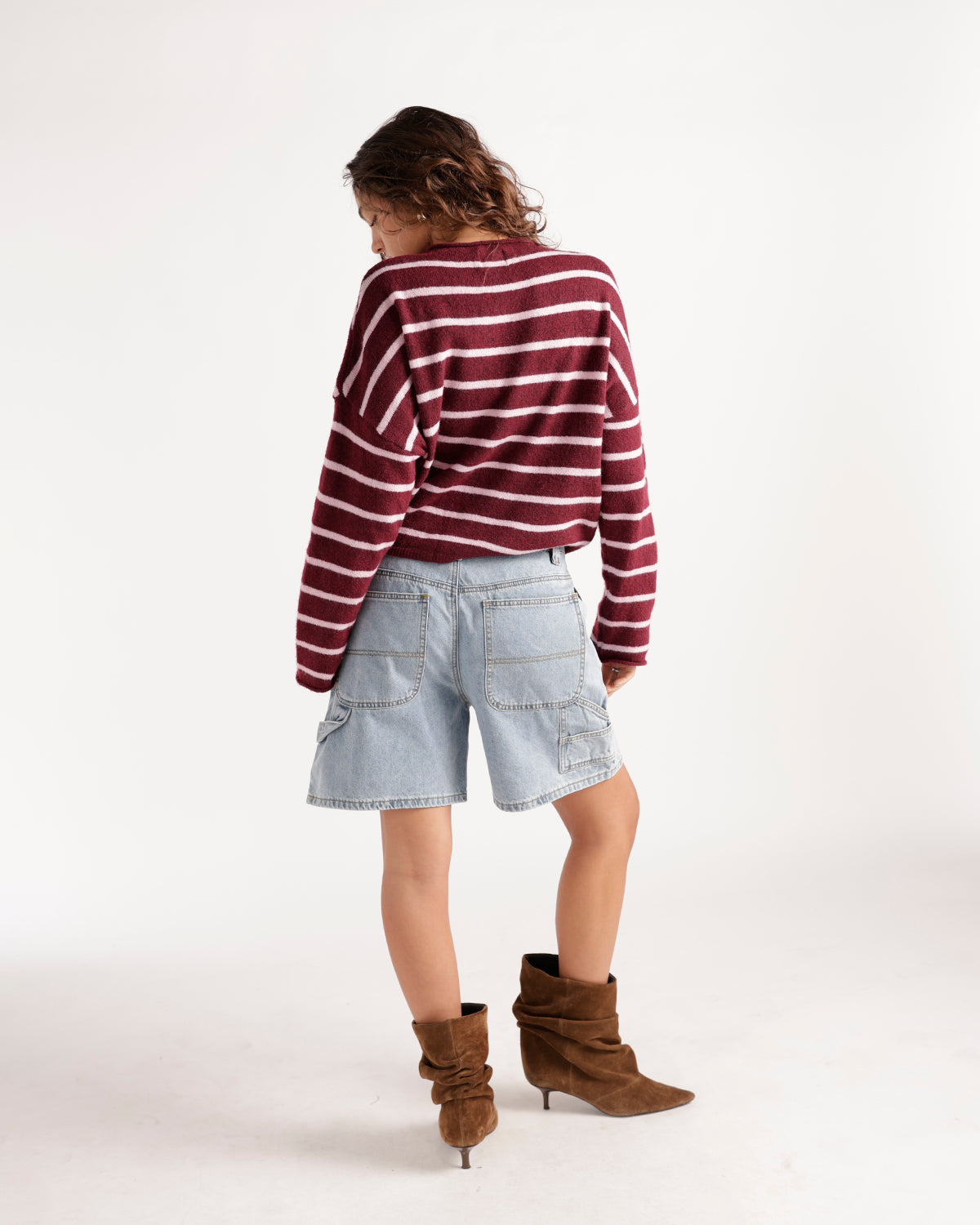 Wine and white striped knit cardigan worn with denim shorts and brown boots