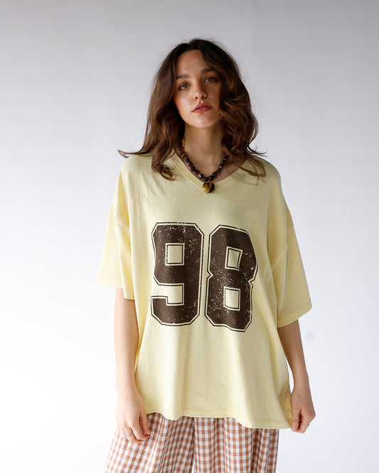 varsity number graphic v-neck tee yellow and brown graphic varsity tee