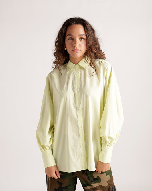 Pale yellow long sleeve button-up shirt with puff sleeves and cuffed wrists