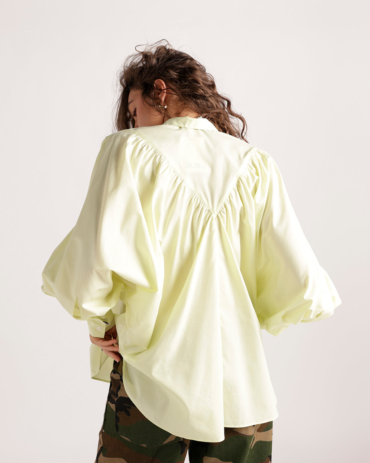 Pale yellow oversized button-up shirt with balloon sleeves and gathered back detail