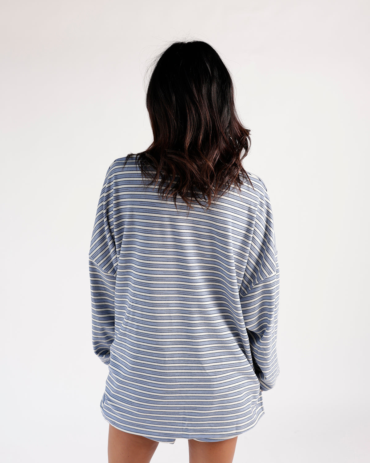Oversized blue and white striped long sleeve top, back view, relaxed fit