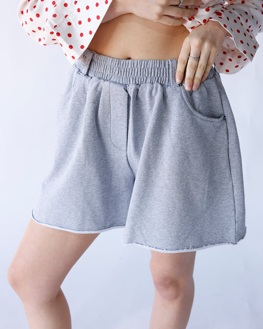 grey sweat shorts with frayed hems and elastic waistband