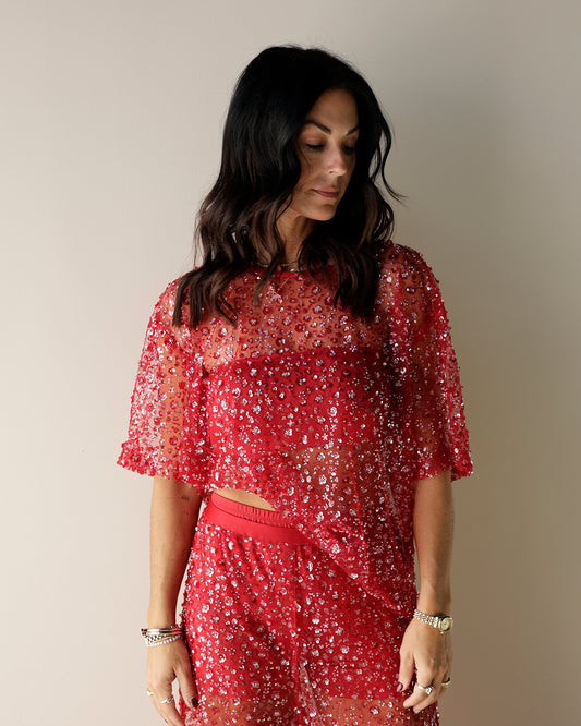 bright red sequin top with model wearing matching pants