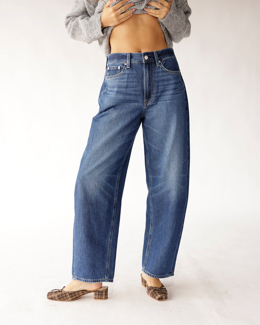 High rise relaxed barrel jeans in medium blue wash, paired with plaid mules