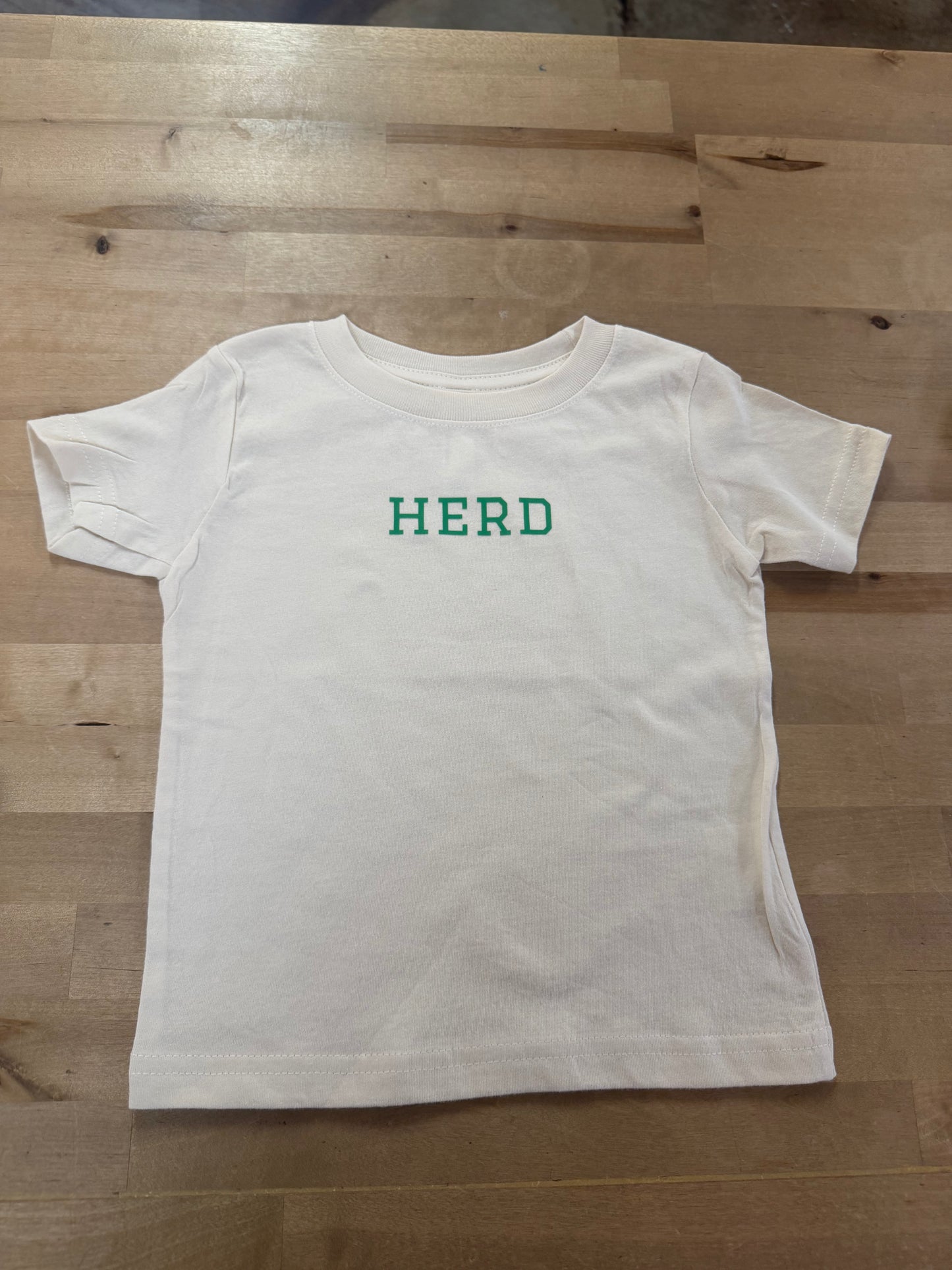 Ivory toddler t-shirt with green HERD text printed on chest