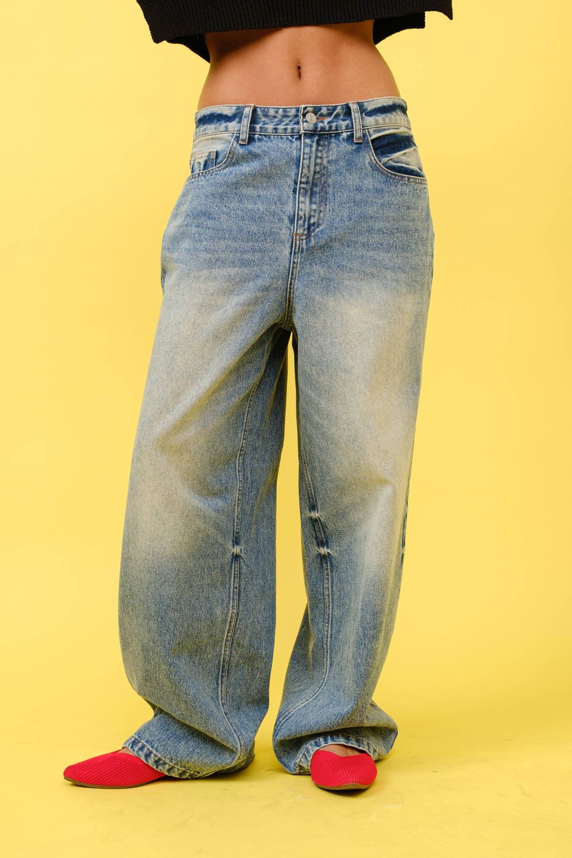 Light wash wide leg jeans with faded finish, low rise, worn with red flats