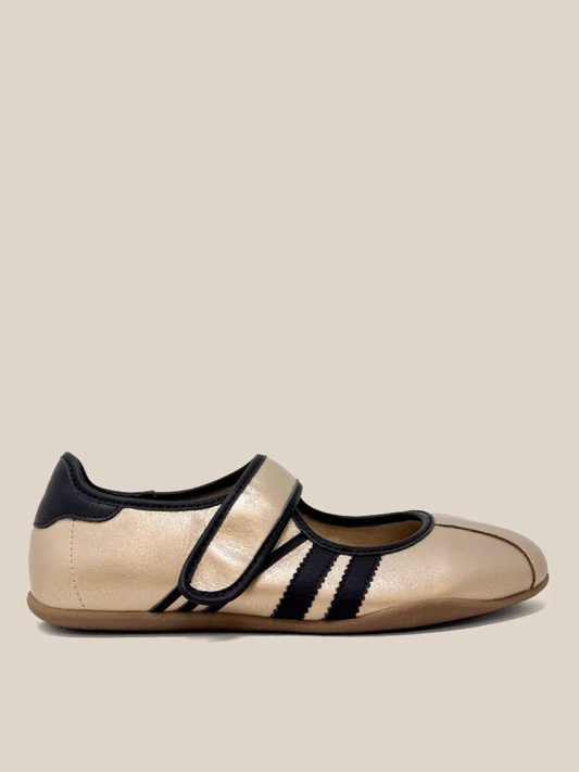Gold metallic Mary Jane flat sneaker with black velcro strap and side stripes