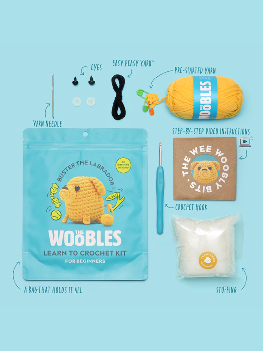 Yellow labrador crochet kit with yarn, hook, needle, eyes, stuffing, and instructions
