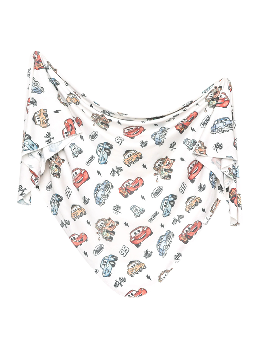 White swaddle blanket with Disney Pixar Cars characters and racing flag print