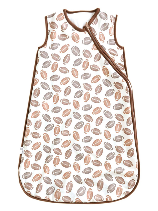 White baby sleep sack with brown and tan football print and brown trim