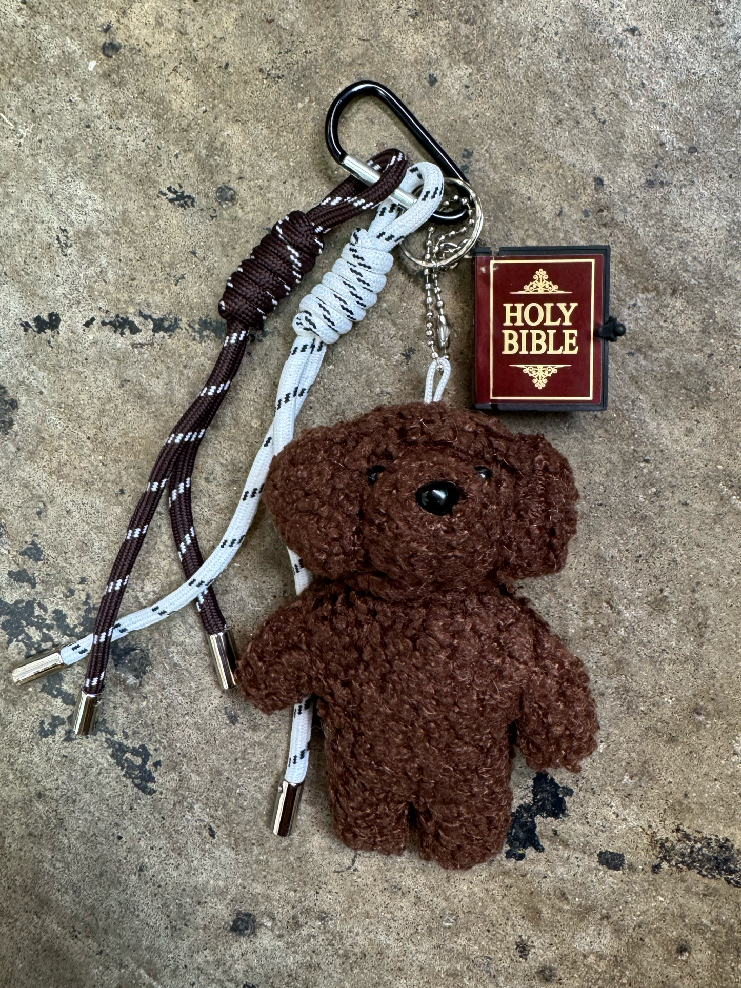 keychain with brown and white rope charms, small stuffed brown puppy and a mini bible