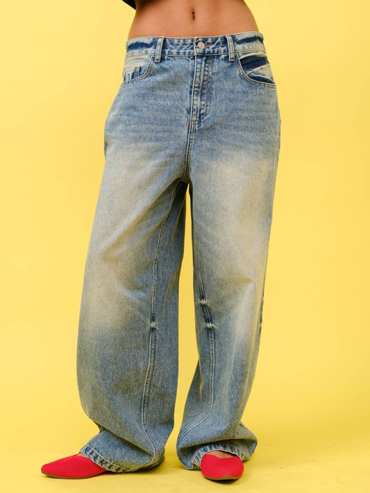 Light wash wide leg jeans with faded detailing, worn with red flats