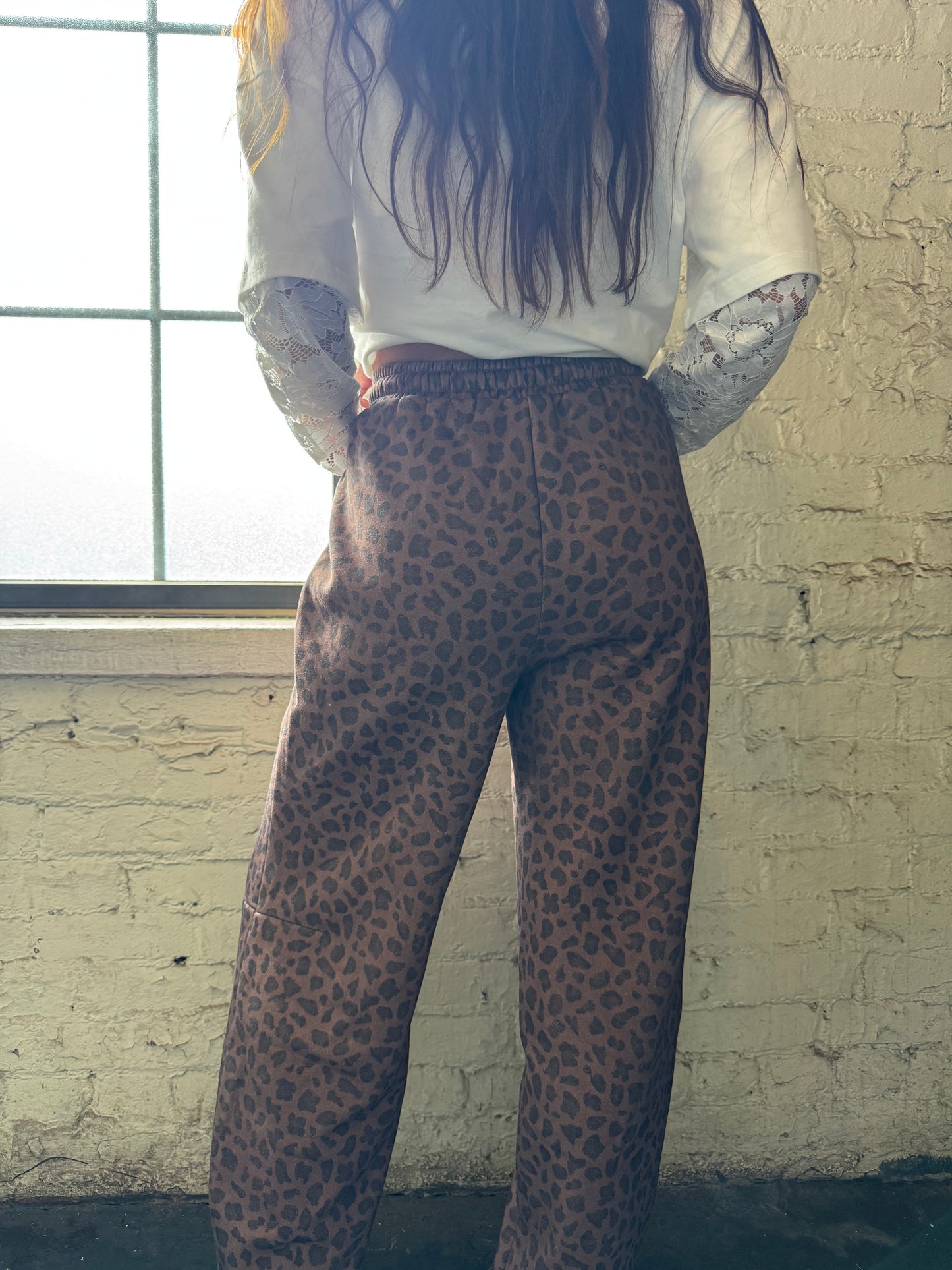 HIP LEANING INTO LEOPARD BARREL JOGGER