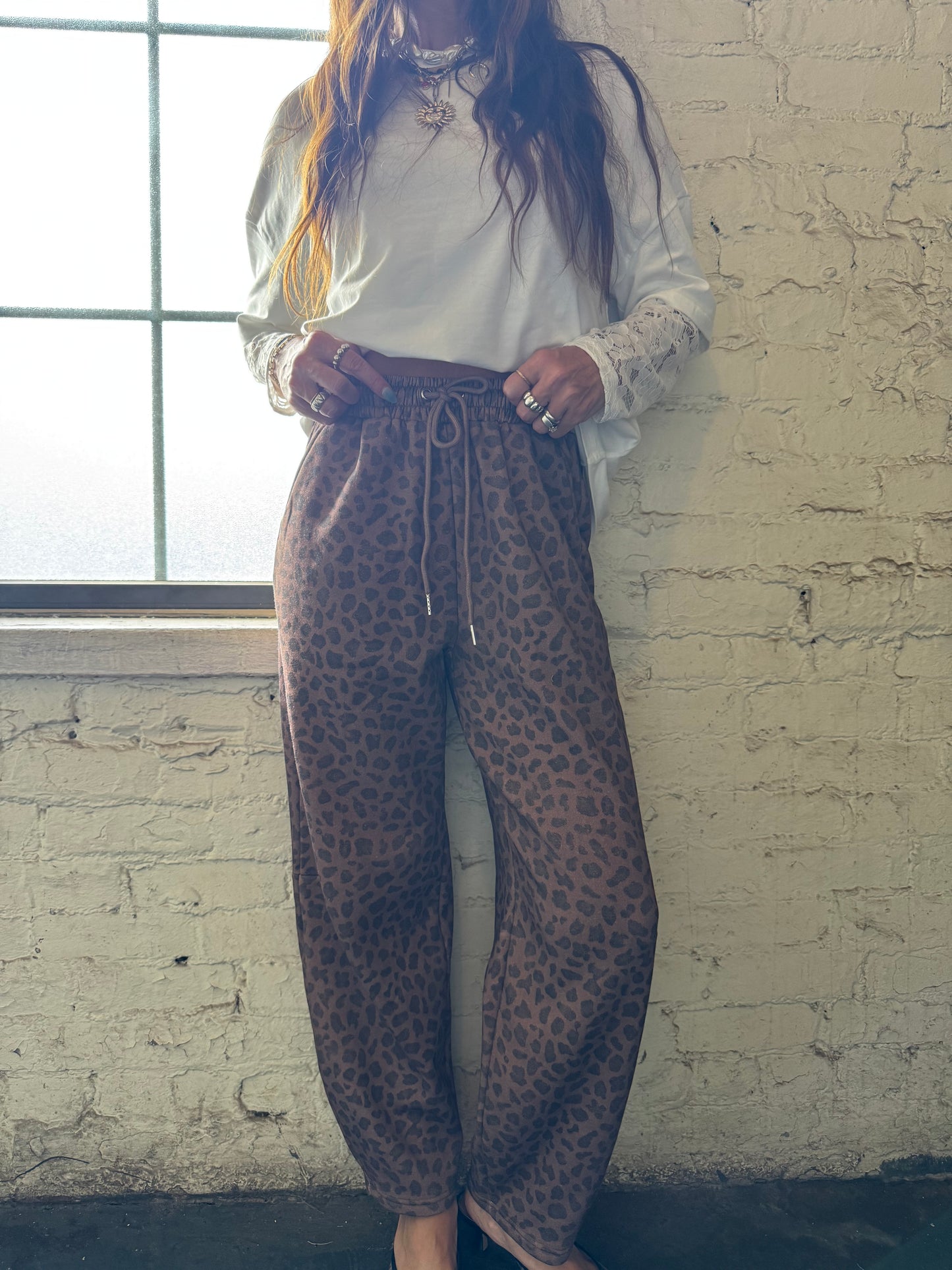 HIP LEANING INTO LEOPARD BARREL JOGGER