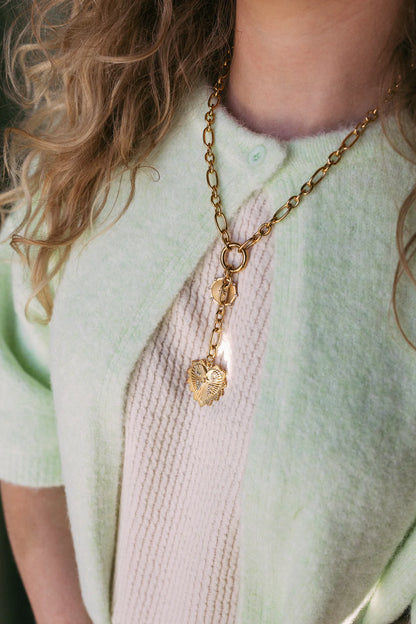 Gold chain lariat necklace with two textured heart charms, styled on model