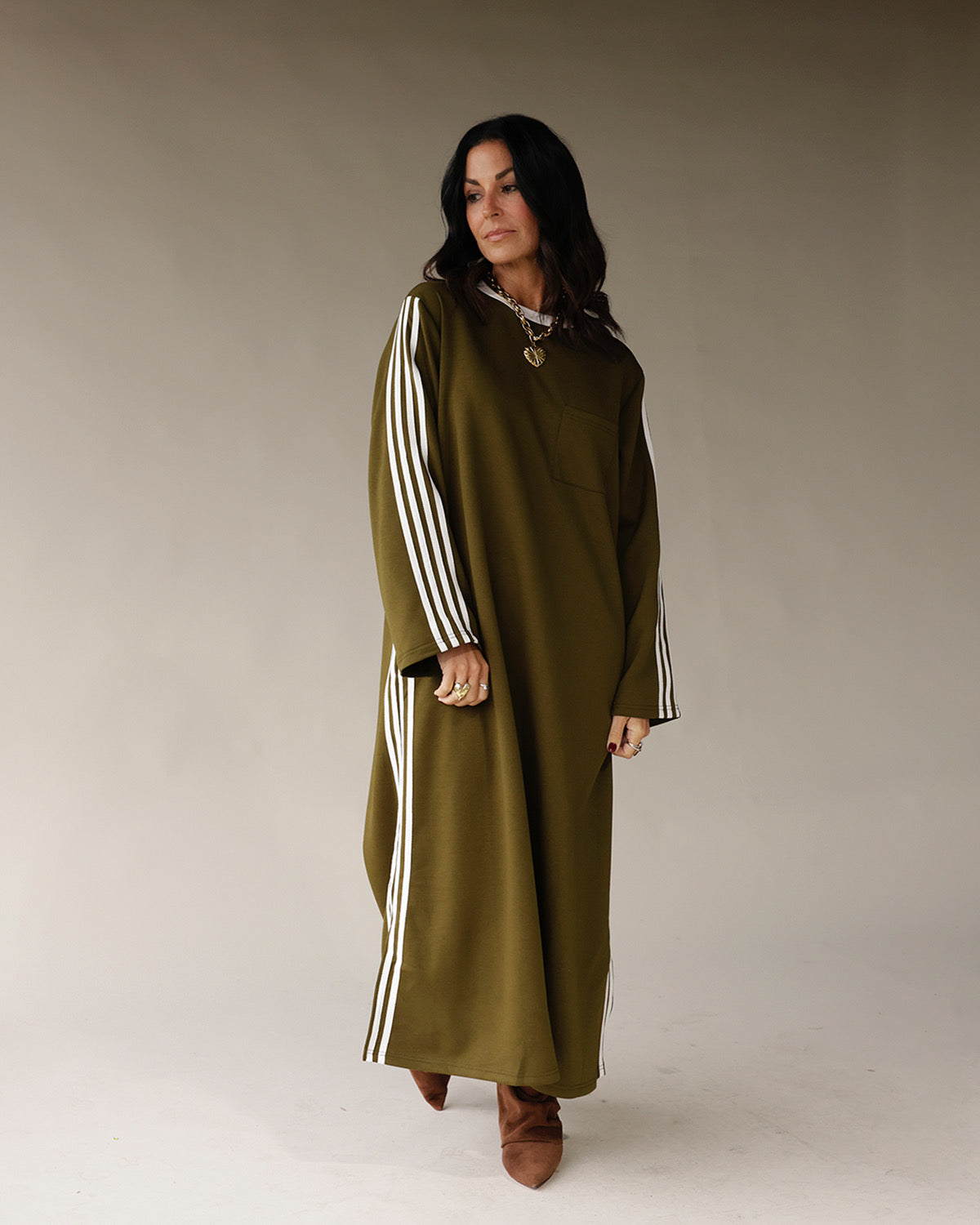 Olive green maxi dress with white varsity stripes on sleeves and sides