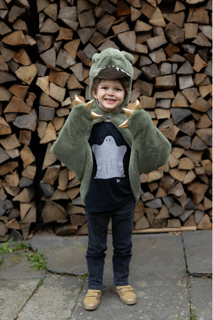 Child wearing green plush T-rex dinosaur cape with hood and gold spikes