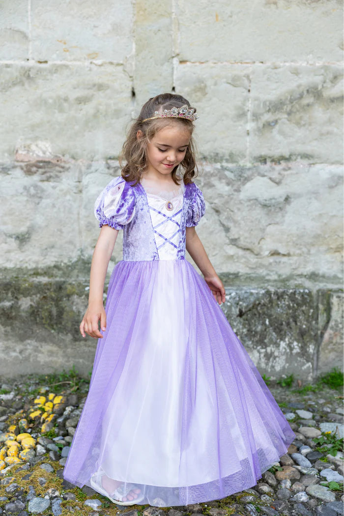 Girl wearing purple velvet and tulle princess dress with tiara and pendant