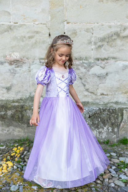 Girl wearing purple velvet and tulle princess dress with tiara and pendant