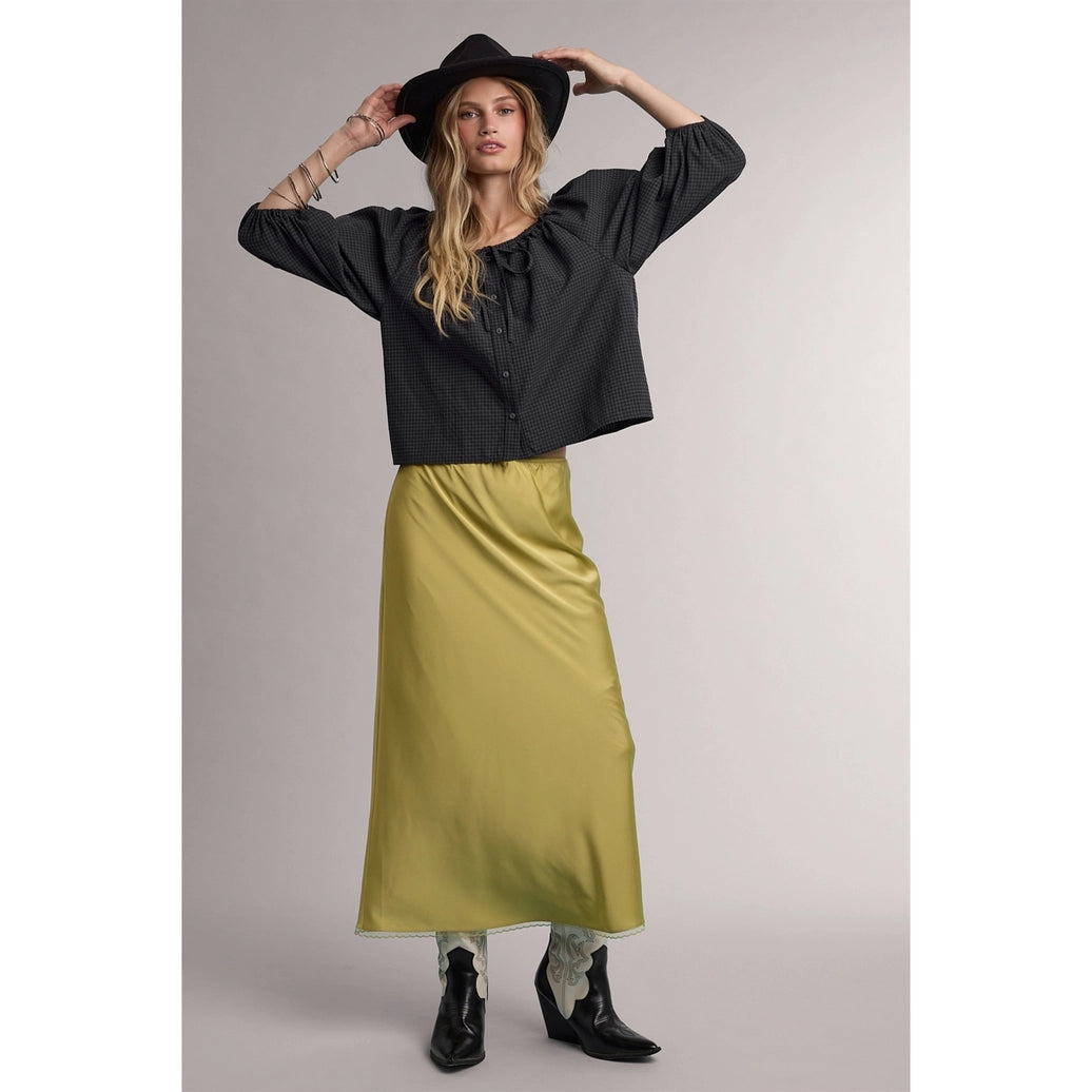 Olive green satin midi skirt with lace trim hem, paired with dark blouse