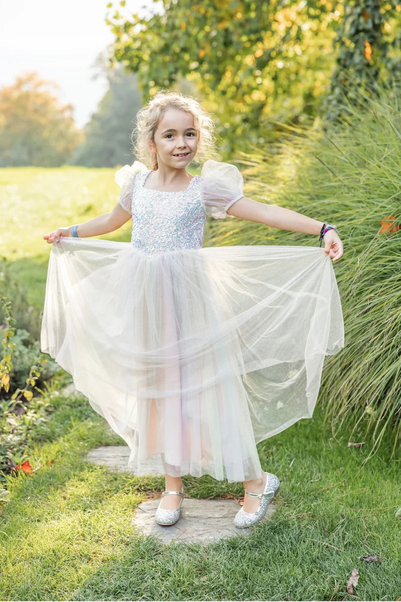 Girl wearing pastel rainbow tulle dress with sequin bodice and puff sleeves
