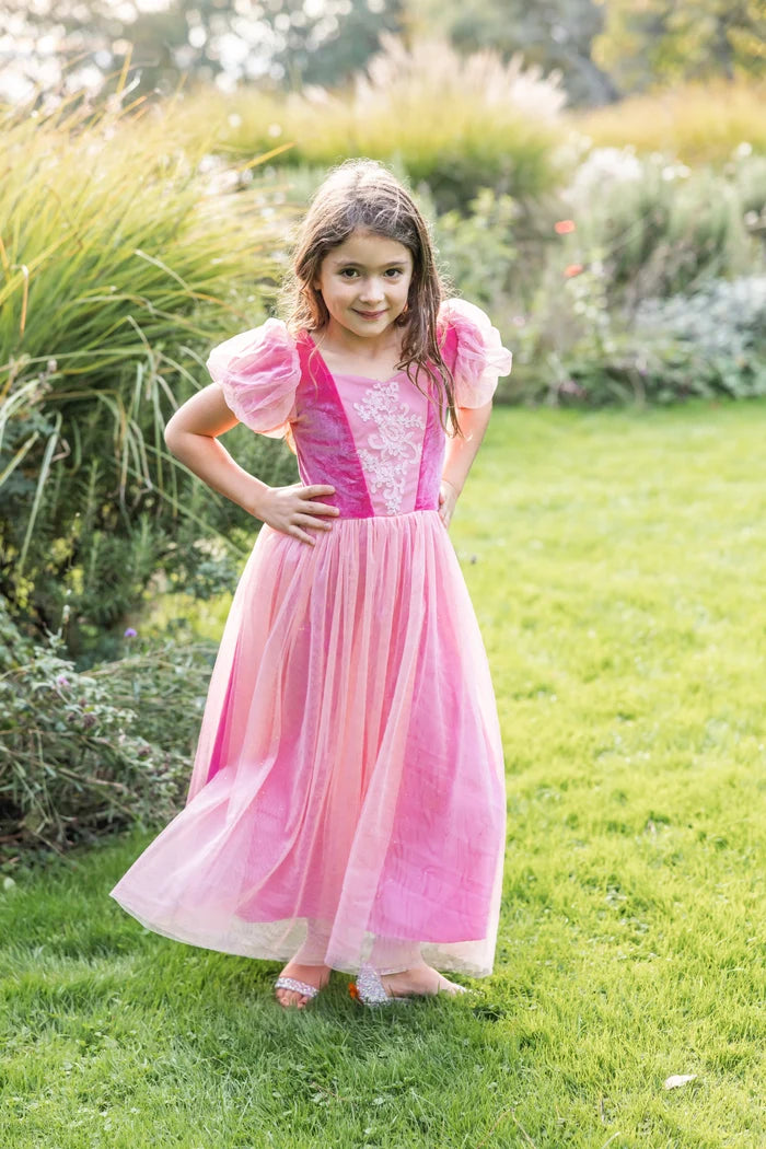 Girl wearing a floor-length pink princess dress with puff sleeves and lace detail