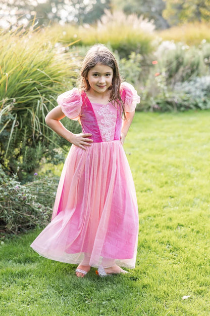 Girl wearing a floor-length pink princess dress with puff sleeves and lace detail