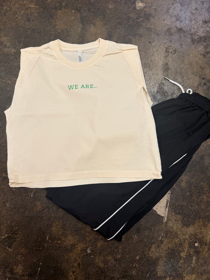 Off-white sleeveless muscle tee with green WE ARE... text on chest
