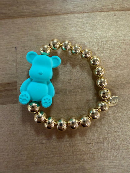 Gold beaded stretch bracelet with turquoise blue teddy bear charm centerpiece