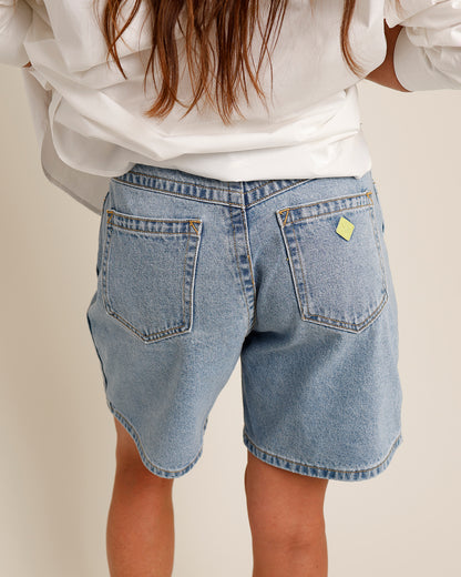 mid-weight indigo denim high waisted relaxed fit wide leg light blue stonewash faded gold stitching mid length denim shorts