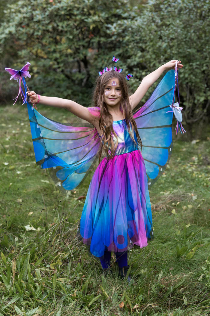 Girl wearing blue pink butterfly costume dress with wings and butterfly headband