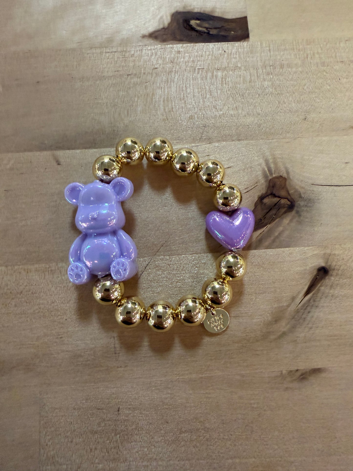 Stretchy gold bead bracelet with lavender bear charm and purple heart bead