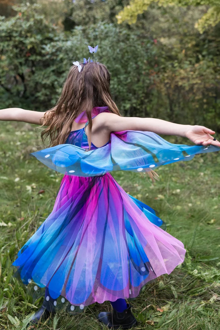 Girl wearing blue pink purple butterfly costume dress with wings and butterfly headband